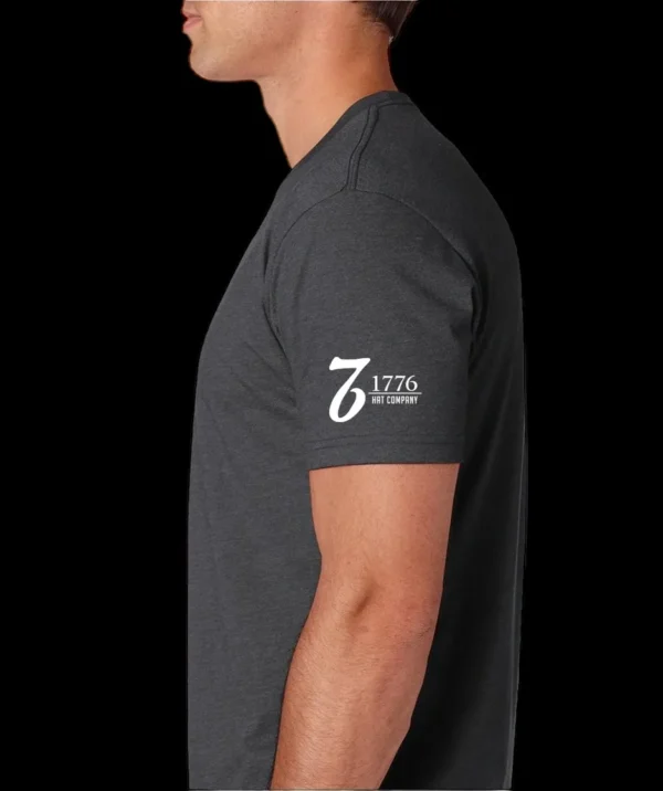 A man wearing a black shirt with the number 7 6 on it.