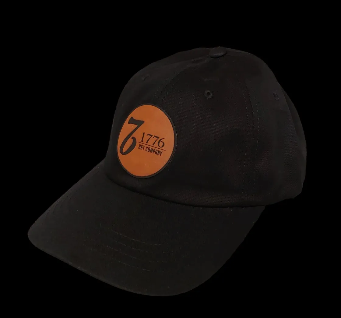 A black hat with an orange circle on it.