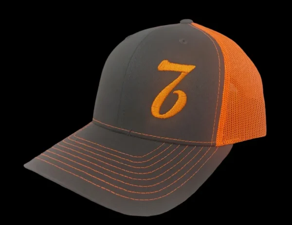 A gray and orange hat with the number seven on it.