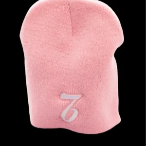 A pink beanie with the number seven on it.