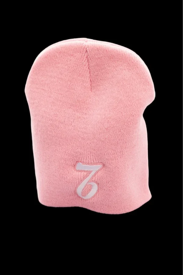 A pink beanie with the number seven on it.