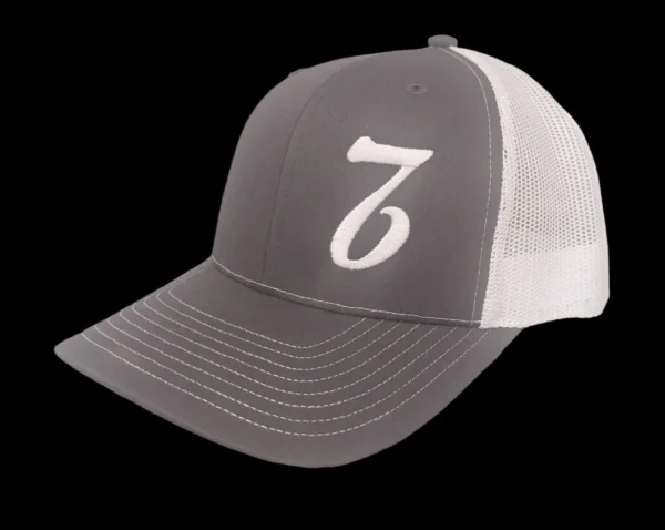 A gray and white hat with the number seven on it.