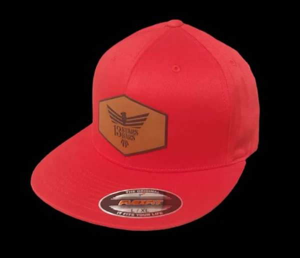 A red hat with a leather patch on it.