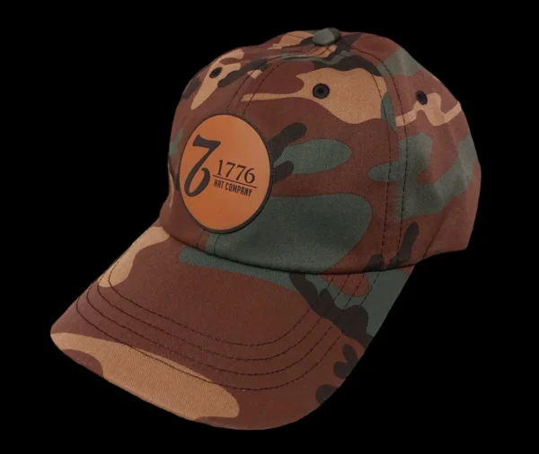 A brown and green camouflage hat with the number 7 1 2 0.